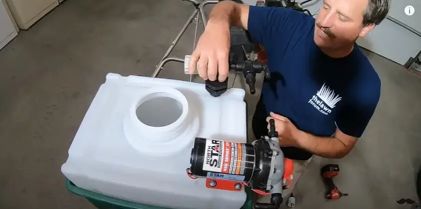 Install the pressure relief valve by drilling a hole atop the tank, using Teflon tape, screws and nuts. | Source: YouTube/Connor Ward
