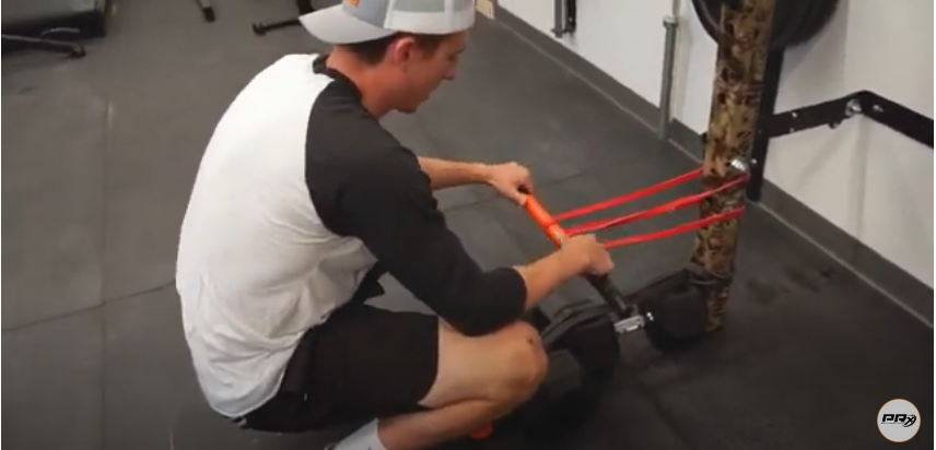 Secure another resistance band slightly higher than the first one | Source: YouTube/@prxperformance