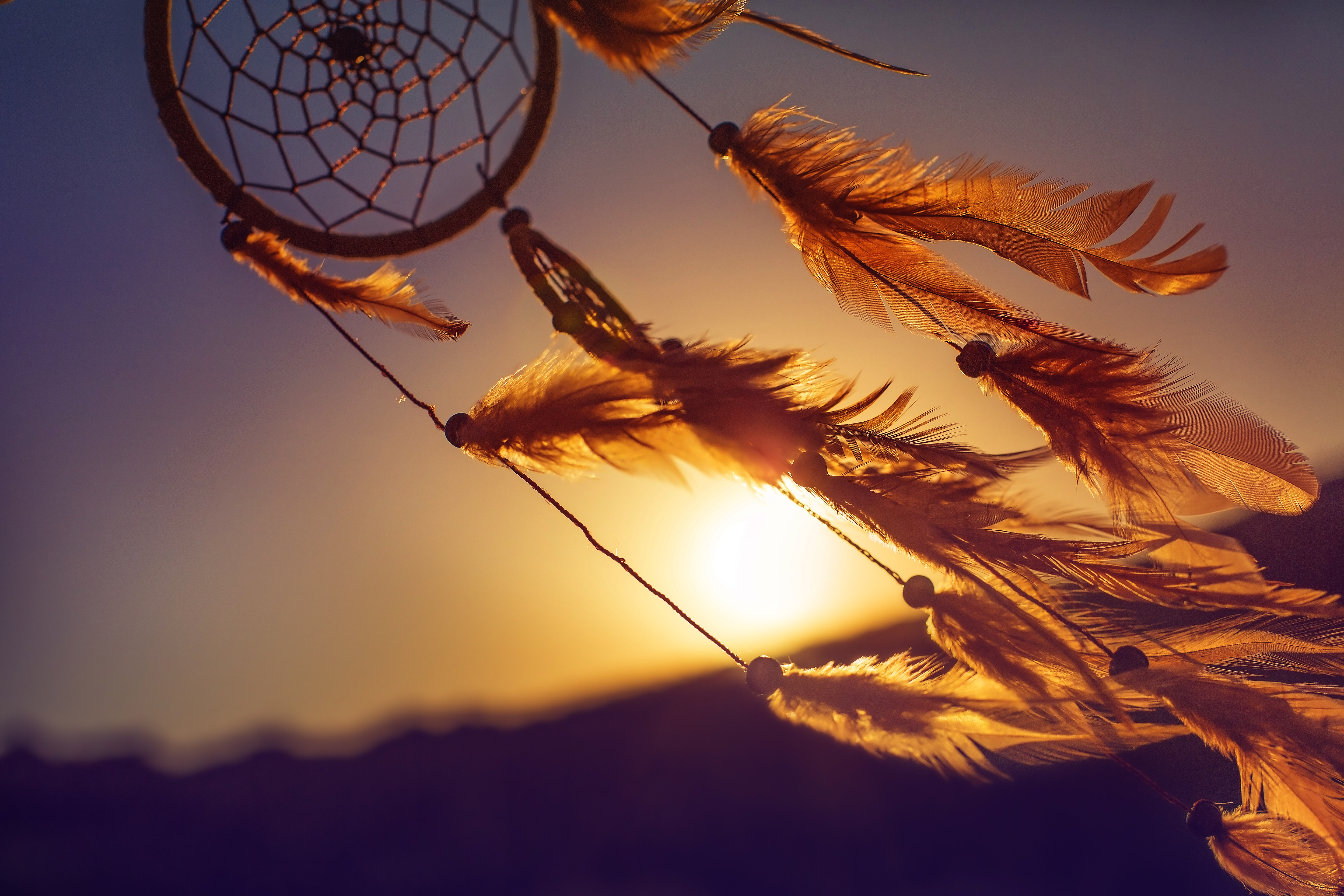 A dreamcatcher blown by the wind during sunset | Source: Shutterstock