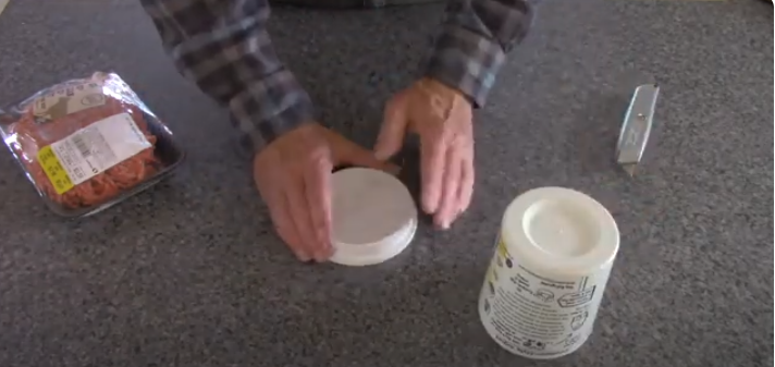Place the plastic wrap on top of the lid. | Source: YouTube/@RoadtrekRich
