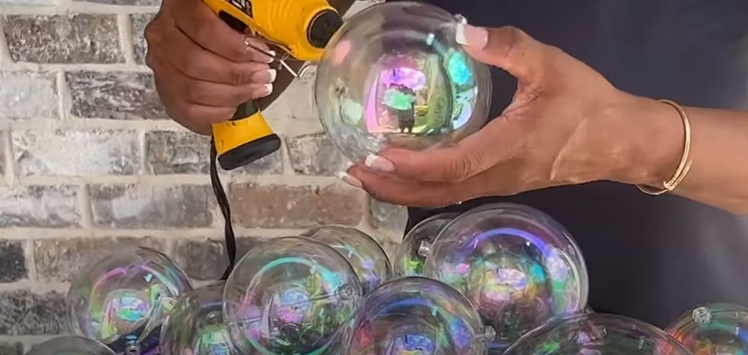 Use a glue gun to keep the orbs intact | Source: YouTube/@JustJeannieJ