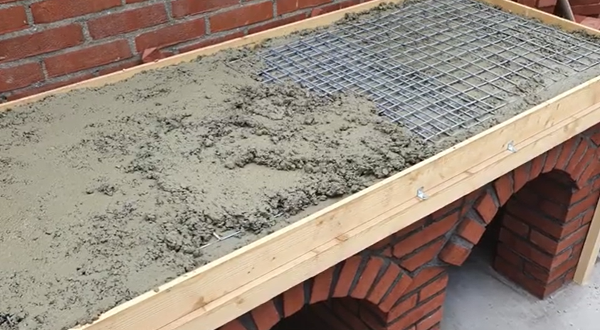 A screenshot of the countertop being filled with cement | Source: YouTube/Joris Velden