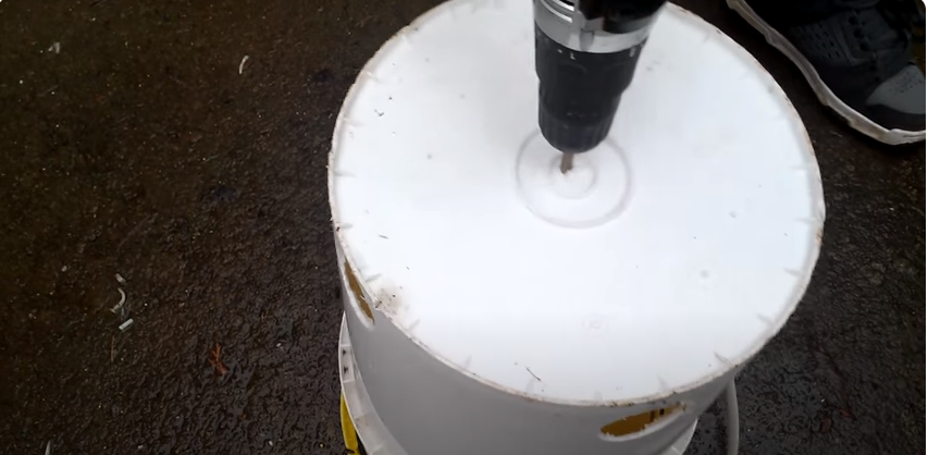 A white bucket being drilled upside down | Source: YouTube/@randomthingschannel979