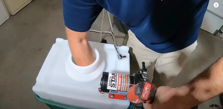 Mount the pump to the tank by marking and drilling holes to secure the pump using nuts and screws. | Source: YouTube/Connor Ward