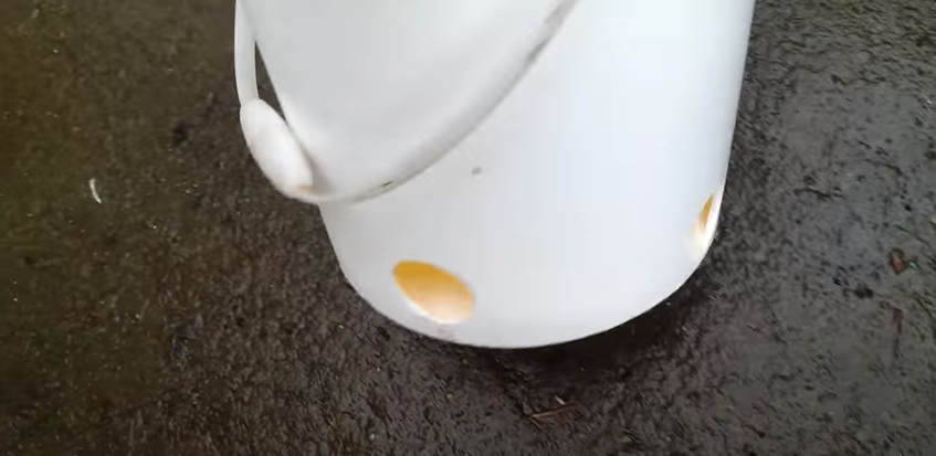 A white bucket with round holes | Source: YouTube/@randomthingschannel979