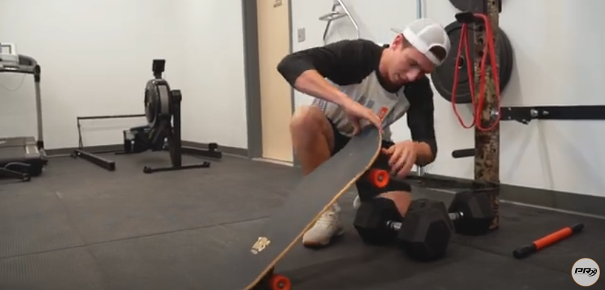 Attached the resistance band on your skateboard | Source: YouTube/@prxperformance