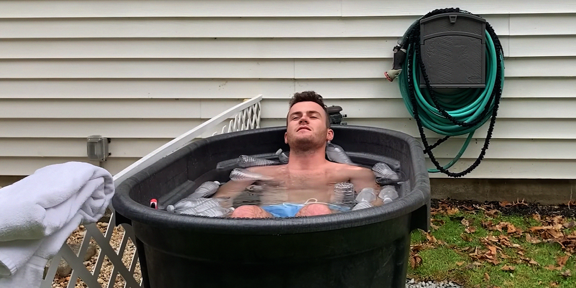 A man in a DIY cold plunge container | Source: YouTube.com/@GetAheadWithNick