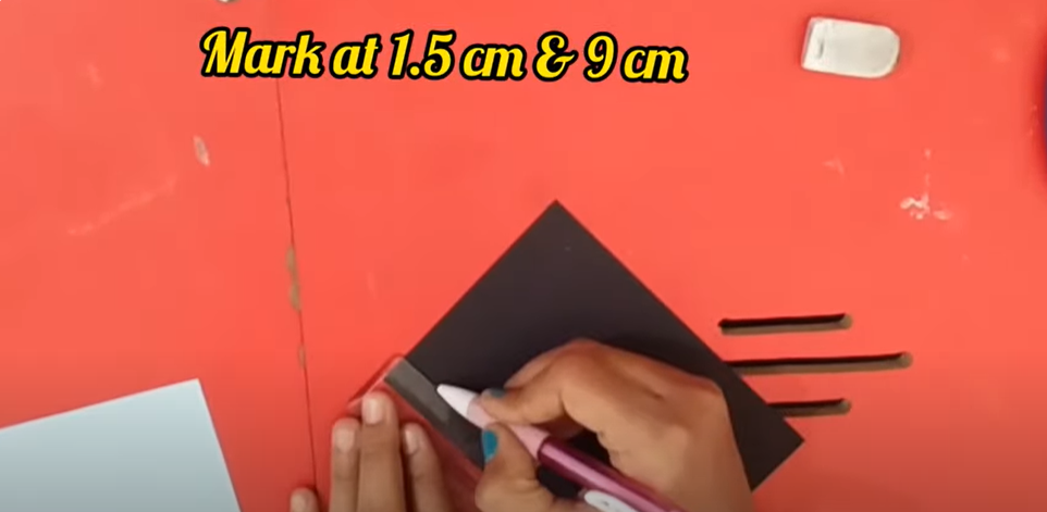 A person creating a DIY birthday banner | Source: YouTube/@hinalscreation1310