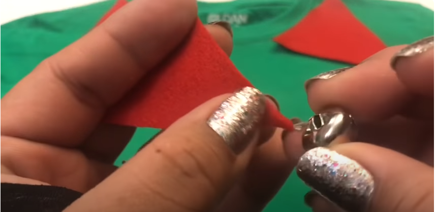 Insert a section of the red cloth inside the bells | Source: YouTube/@craftingwithgaby