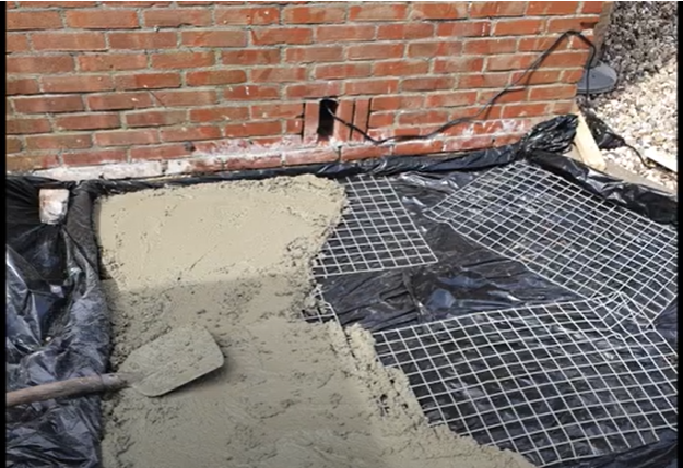 A screenshot of an Argentine grill foundation being laid | Source: YouTube/Joris Velden