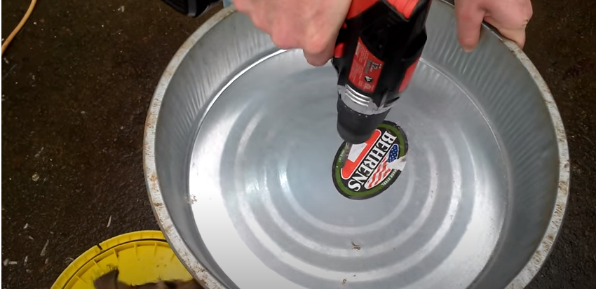 A person drilling a pan | Source: YouTube/@randomthingschannel979