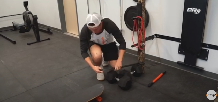 Hold your resistance band as illustrated in the image | Source: YouTube/@prxperformance