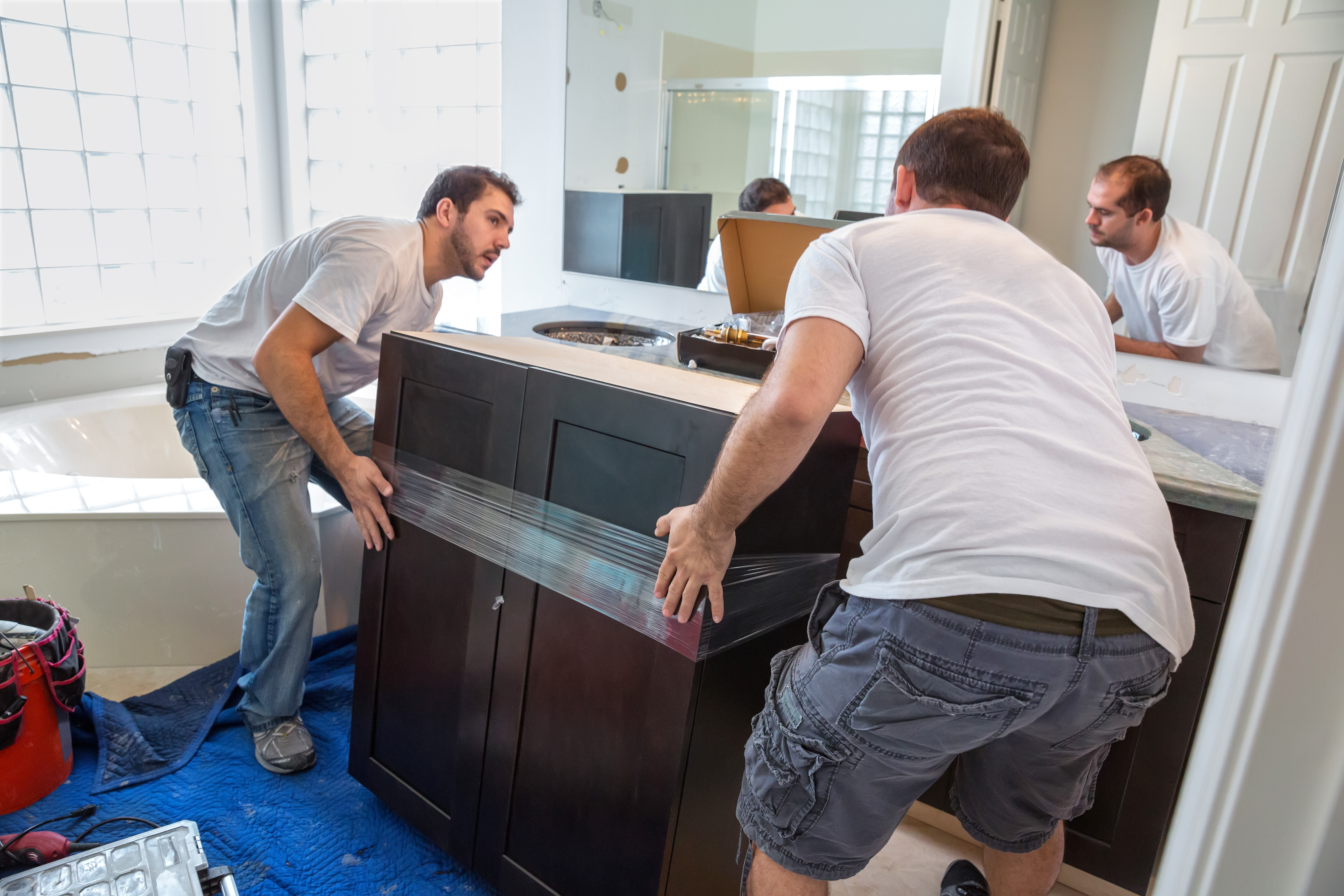 Two men doing major remodeling to a bathroom | Source: Getty Images