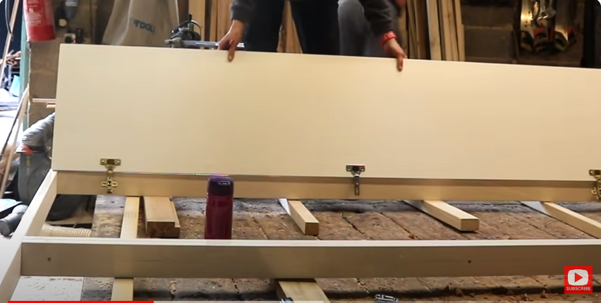 A  person test-fitting wardrobe doors | Source: YouTube/@TheCarpentersDaughterUK