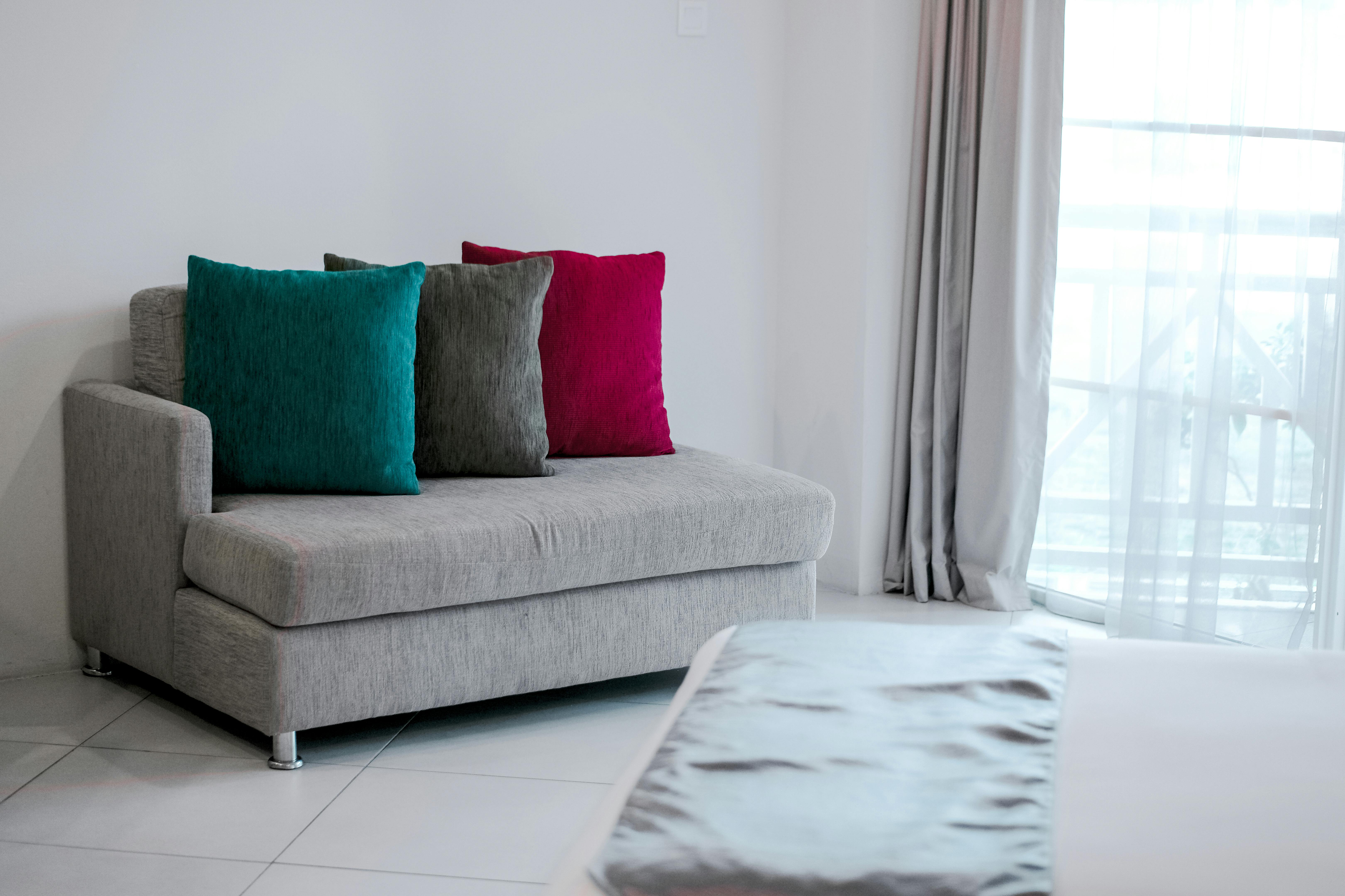 A small sofa decorated with throw  pillows | Source: Pexels