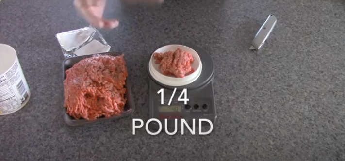 Place beef inside the plastic wrap. | Source: YouTube/@RoadtrekRich