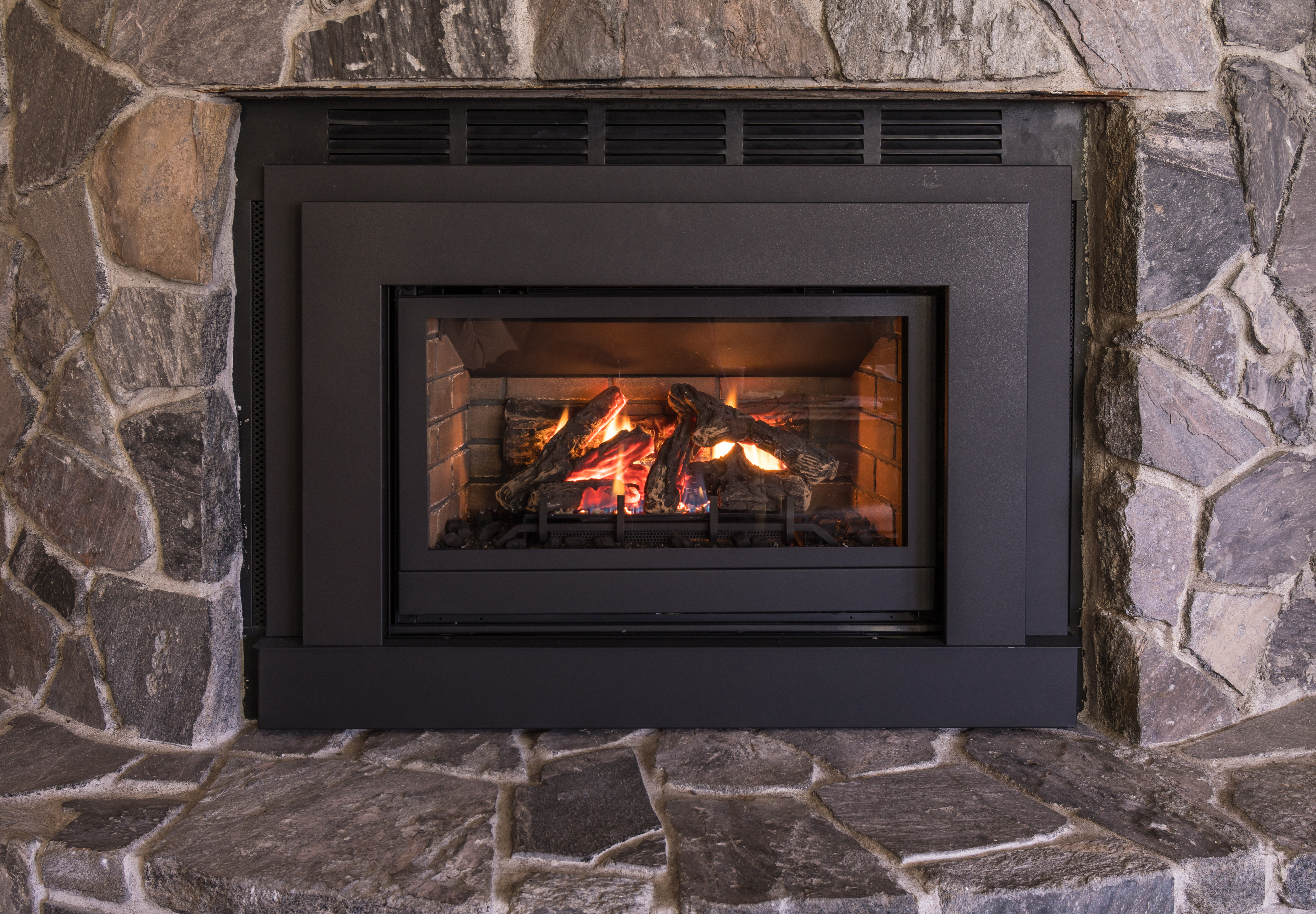 A well-lit gas fireplace | Source: Shutterstock