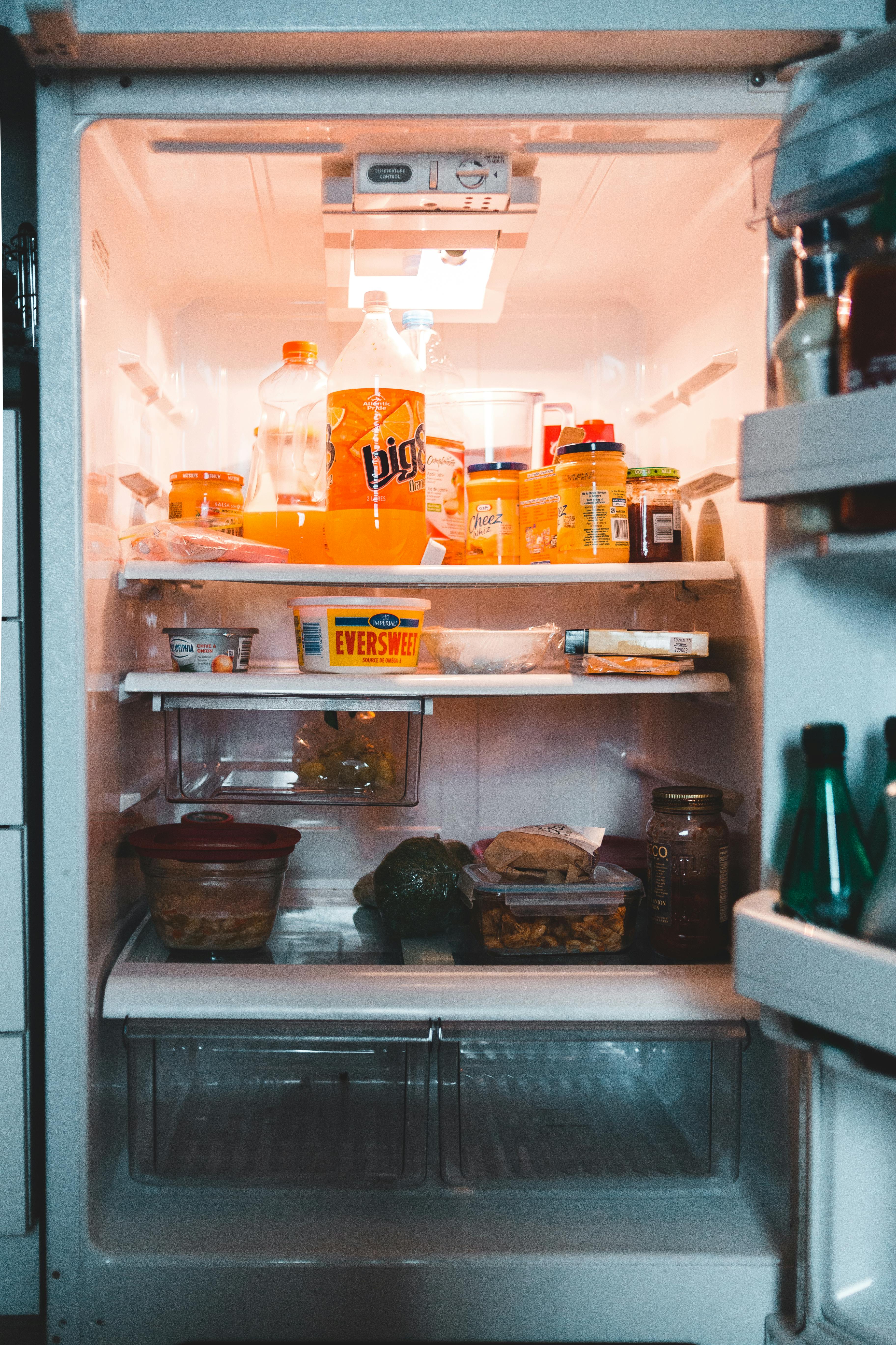 Opened fridge with drinks and food |  Source: Pexels