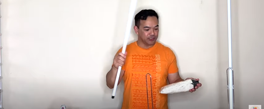 A person holding a floor mop | Source: YouTube/fambamny/videos