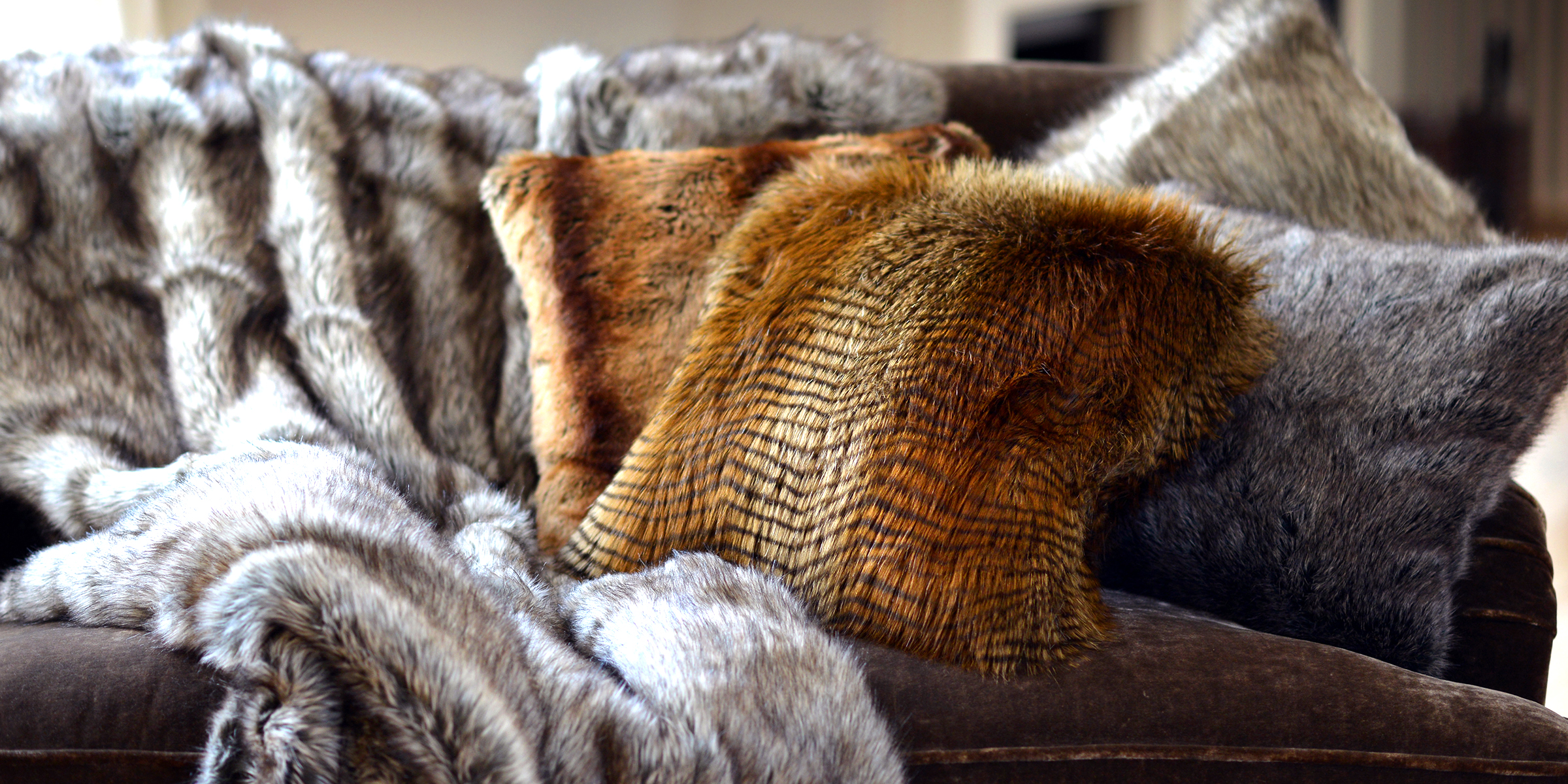 A gray faux fur blanket rests on the sofa. | Source: Shutterstock